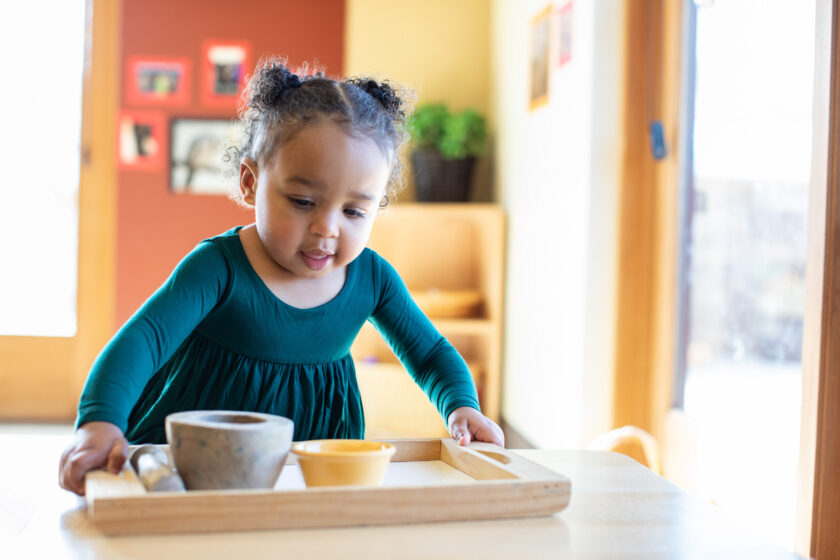 toddler holding tray.