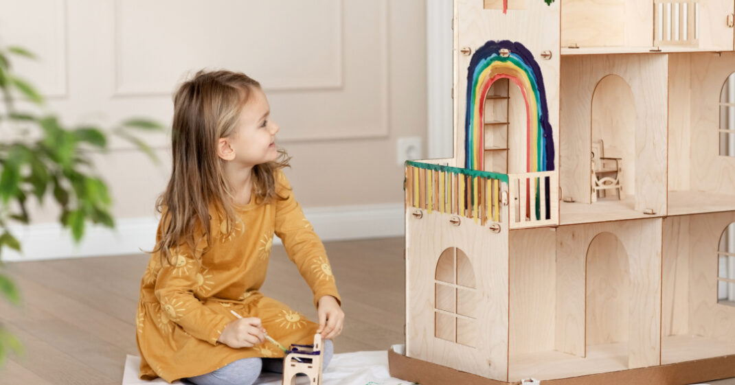 kindergarten age child playing with wooden blocks